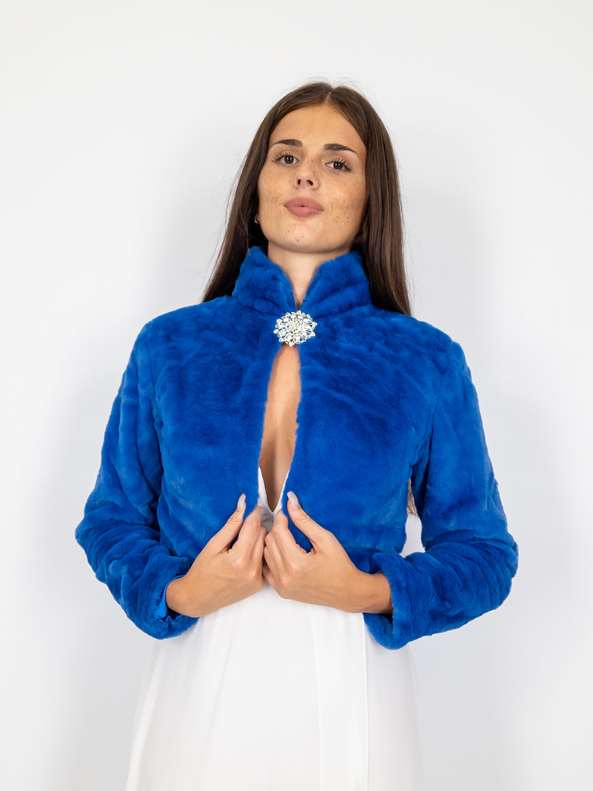 Elegant short faux fur jacket with decorative brooch