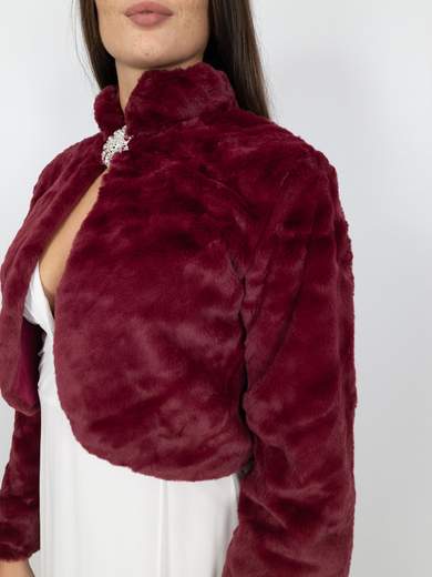 Elegant short faux fur jacket with decorative brooch