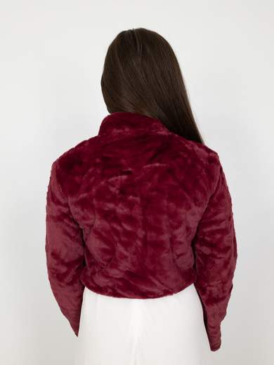 Elegant short faux fur jacket with decorative brooch